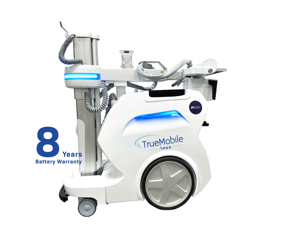 A JPI Healthcare Solutions "TrueMobile Apex" portable digital X-ray machine is shown in profile against a black background. The machine is white with blue LED lights and has "TrueMobile Apex" and the JPI Healthcare Solutions logo printed on its side. To the left of the machine, a white speech bubble with a blue outline contains the text "8 Years Battery Warranty."