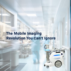 A sleek, white TrueMobile APEX mobile imaging unit positioned in a brightly lit, modern hospital hallway with blurred healthcare staff in the background.